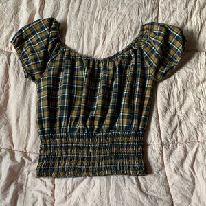 a yellow and navy blue off the shoulder cropped shirt